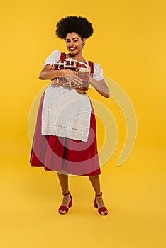 joyful african american oktoberfest waitress with