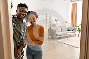 Joyful African Family Couple Embracing Standing In Doors At Home