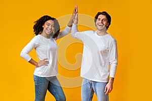 Joyful Afro Girl And White Guy Giving Figh-Five To Each Other