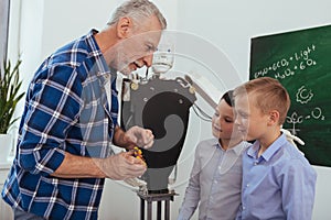 Joyful aged man talking to his pupils