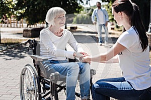 Joyful aged woman being thankful for support