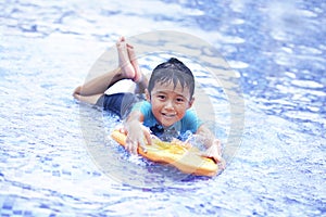 Joyful Asian kid at swimming pool