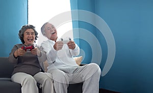 Joyful Asian Senior couple playing games
