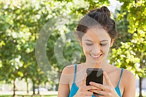 Joyful attractive woman dialling with her smartphone