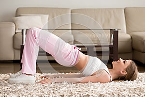 Woman in sportswear doing hip bridge exercise
