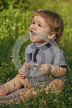 Joyful baby boy on grass