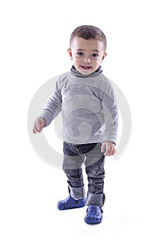 Joyful Baby Boy Standing over White