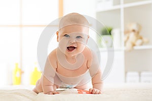 Joyful baby crawling on the floor in nursery room