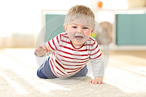 Joyful baby crawling towards camera