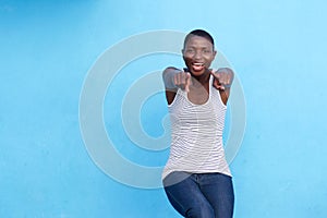 Joyful beautiful woman laughing and pointing fingers