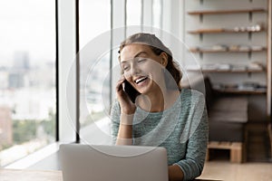 Joyful beautiful woman multitasking in modern office.