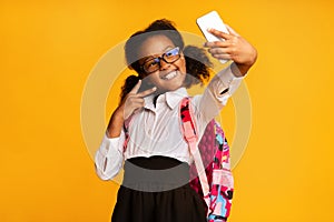 Joyful Black Girl Making Selfie On Smartphone On Yellow Background