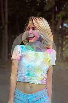 Joyful blonde woman in white t shirt with hair in wind covered d