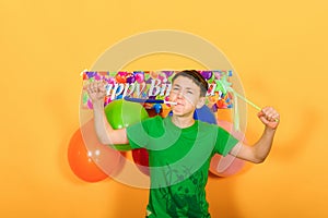 Joyful boy celebrates his birthday on a festive background