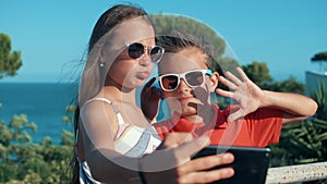 Joyful boy and girl grimacing to camera outdoor. Teenagers enjoying weekend.