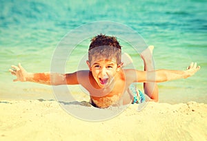 Joyful boy having fun at the beach