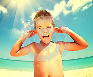 Joyful boy having fun at the beach