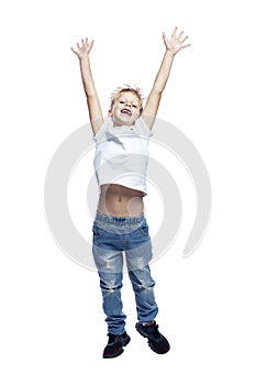 Joyful boy is jumping. A child in jeans and a white T-shirt. Positive, active and energetic. Isolated on white background.