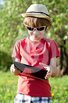 Joyful boy plays in the Tablet PC