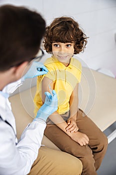 Joyful boy ready for vaccination stock photo