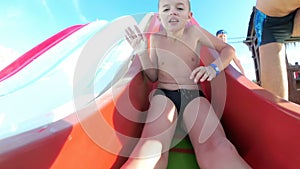 Joyful Boy Slides Down a Water Slide at a Hotel in Egypt. Slow Motion