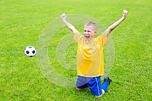 Joyful boy soccer player