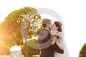 Joyful bride and groom with bouquet