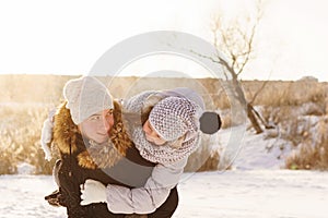 Teens brother and sister having fun snow in winter