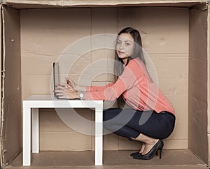 Joyful business woman sitting in the office, working on the comp