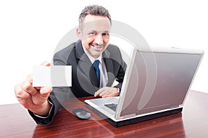 Joyful businessman holding blank business card