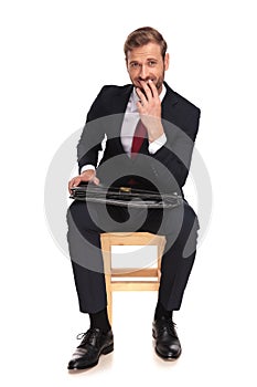 Joyful businessman laughing and thinking while waiting for inter