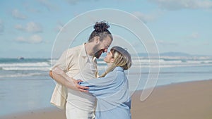 Joyful Caucasian couple having fun at seashore