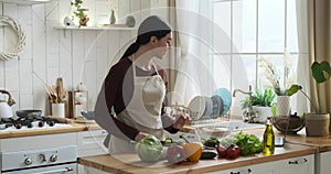 Joyful Caucasian Woman Cooking using Laptop