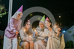 A Joyful Celebration with Friends and Colorful Sparklers at a Night Party Event photo