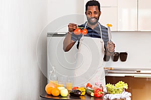 African man preparing healthy food at home in kitchen