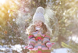 Joyful child having fun with snow