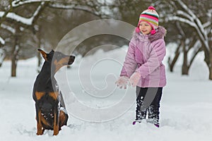 Joyful children playing in snow. Two happy girls having fun outside winter day