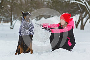 Joyful children playing in snow. Two happy girls having fun outside winter day