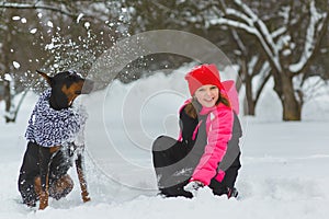 Joyful children playing in snow. Two happy girls having fun outside winter day