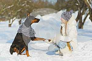 Joyful children playing in snow. Two happy girls having fun outside winter day