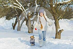 Joyful children playing in snow. Two happy girls having fun outside winter day