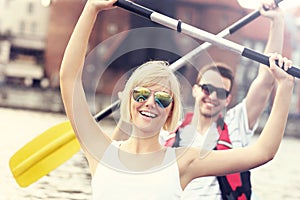 Joyful couple canoeing in the river