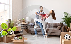 Joyful couple dancing in new apartment