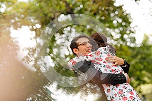 Joyful couple embracing outdoor