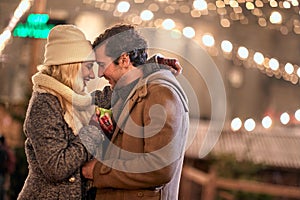 Joyful couple enjoying the winter night; Festive concept
