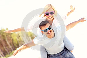 Joyful couple having fun on the beach