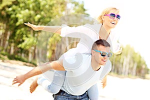 Joyful couple having fun at the beach