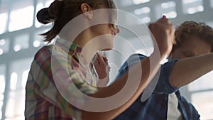 Joyful couple having fun during home repair indoors. Family dancing in house.