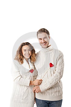 Joyful couple holding red hearts and laughing