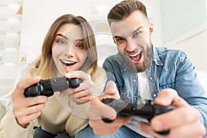 Joyful couple playing video game on Xbox photo